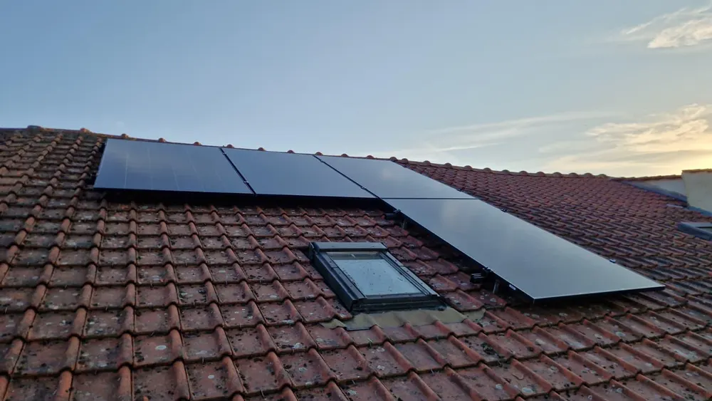Installation de panneaux photovoltaïques sur toiture en tuiles en fin de journée